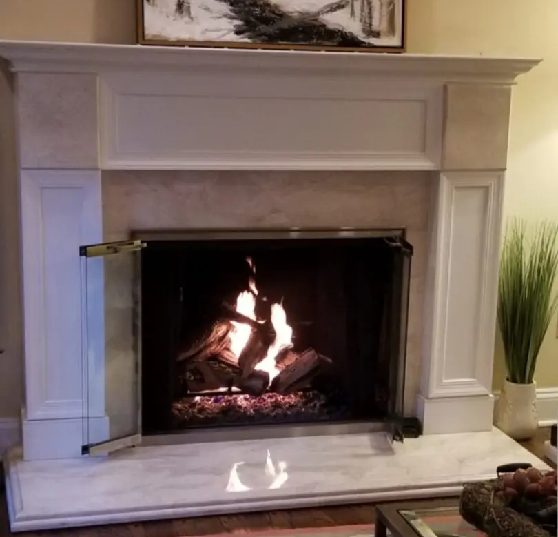 A warm fire burning in a fireplace, creating a welcoming atmosphere in a room.